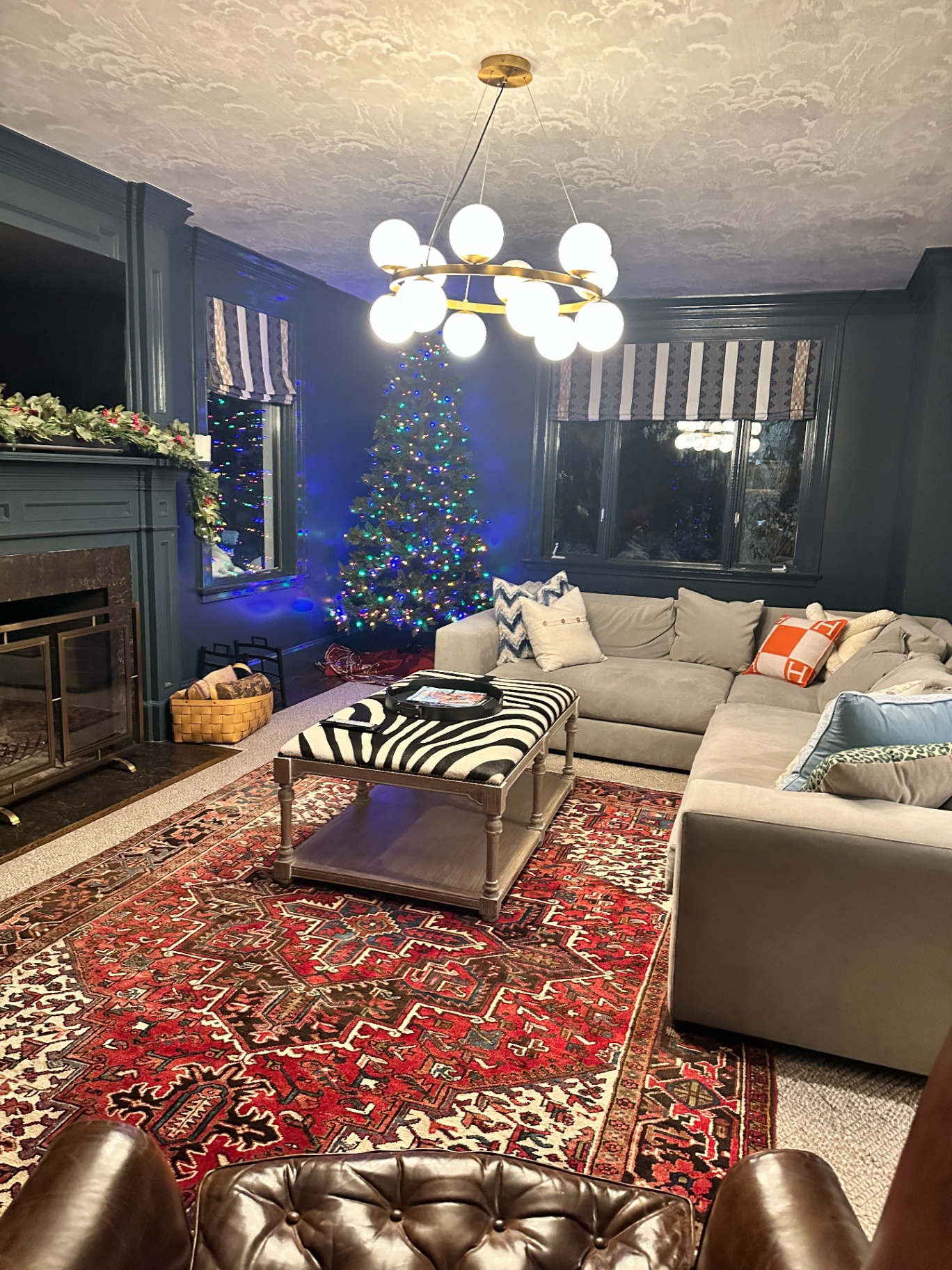 Living room with custom brass globe chandelier installed by ACT Solutions